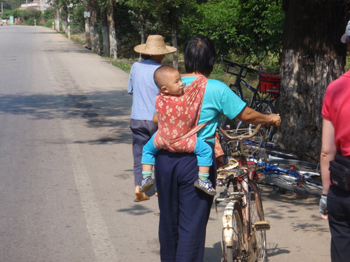 A Grandmother and grandchild on a back-loader.